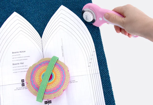 Zuschnitt Strickstoffe mit Rollschneider und Gewichten