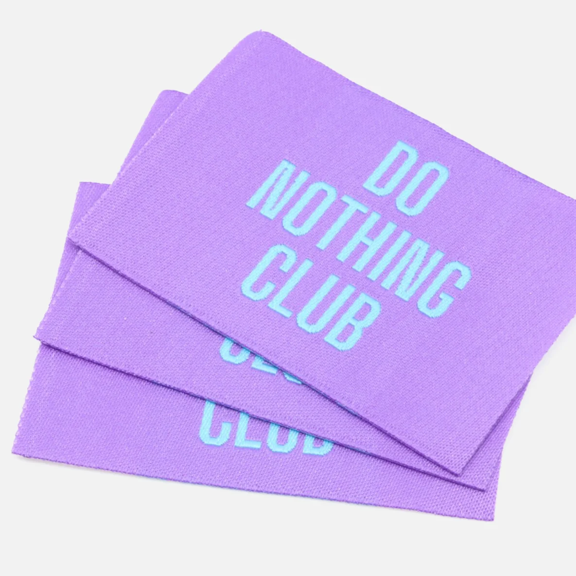 Webetikett "Do Nothing Club", Lila, 57x38 mm, 3 Stück