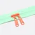 2 Rückseiten Reverse Zipper in Orange 4mm Perlonraupe auf mintfarbenem Endlos-Reißverschluss